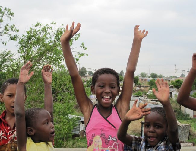 Kid having fun and raising their hands